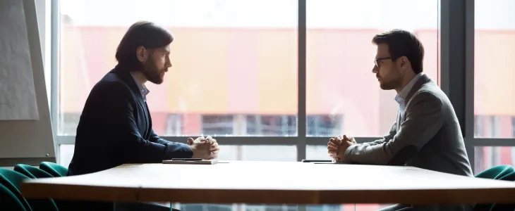 Businessmen in a dispute sitting across from each other
