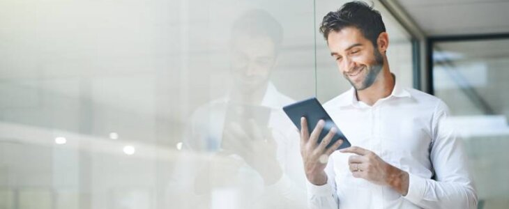 man smiling looking at a tablet intellectual property