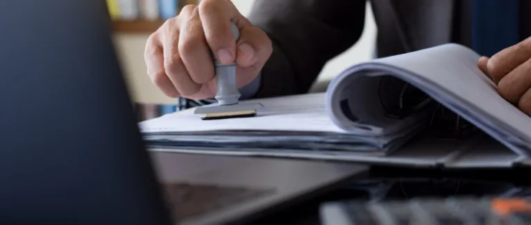 a professional stamping paper in front of a laptop copyright