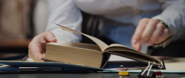 a person going through a large textbook company policies