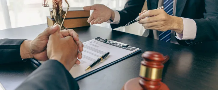 Business client sitting with business attorney