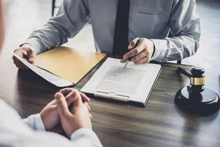 Business client sitting with attorney