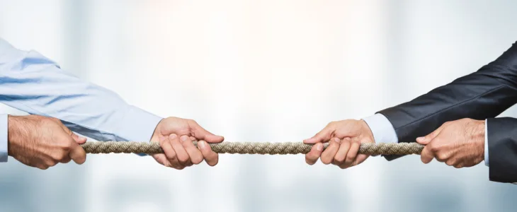 two people pulling rope and illustrating unfair competition