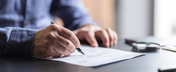 Person signing a business contract