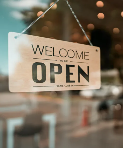 Open cafe or restaurant. Open sign board on glass door in modern cafe